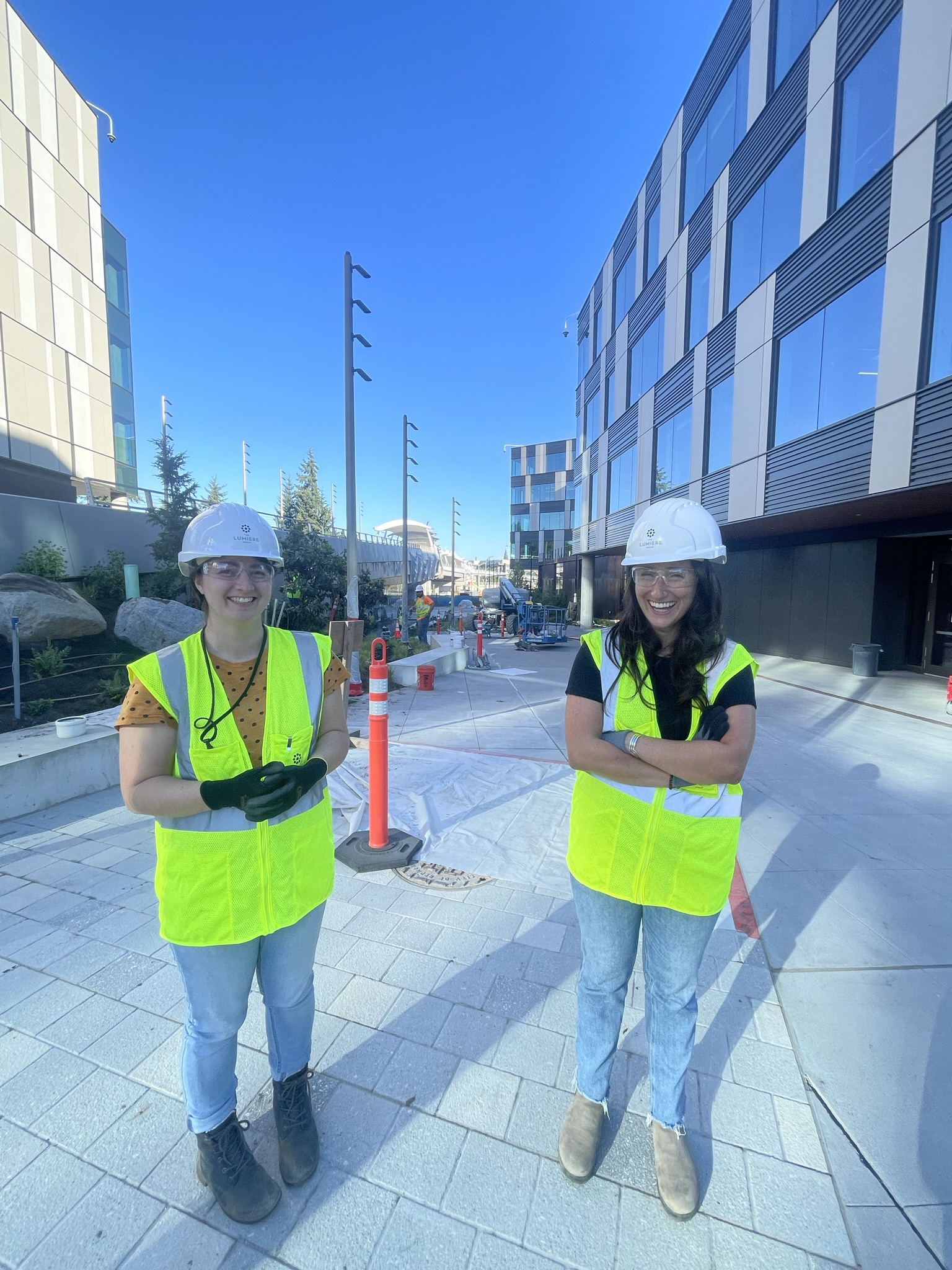 Two women in personal protective gear at a construction site